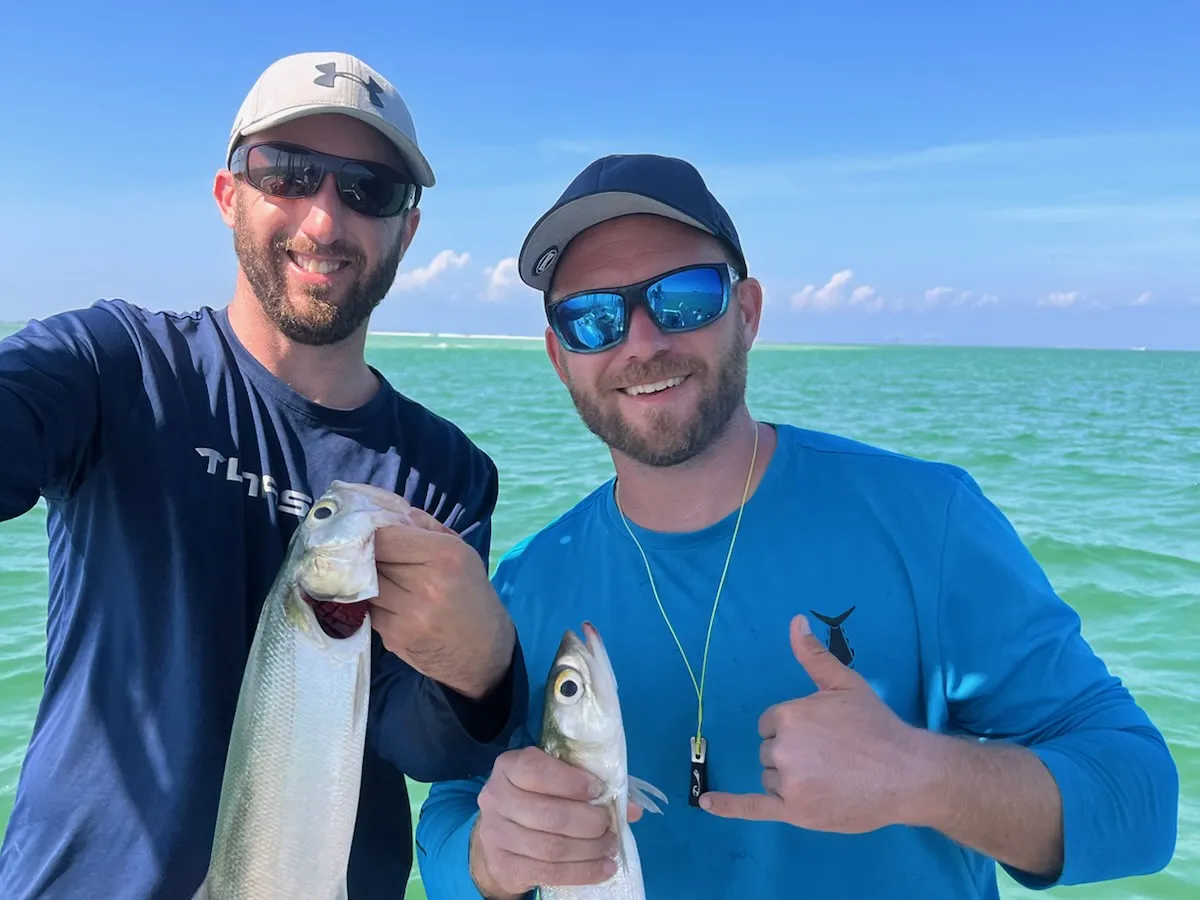 Bryan and his brother holding their catch on the Gulf