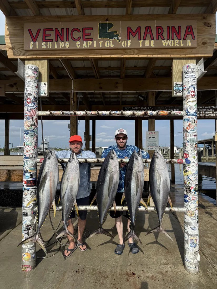 Bryan and his brother at Venice Marina with a row of tuna