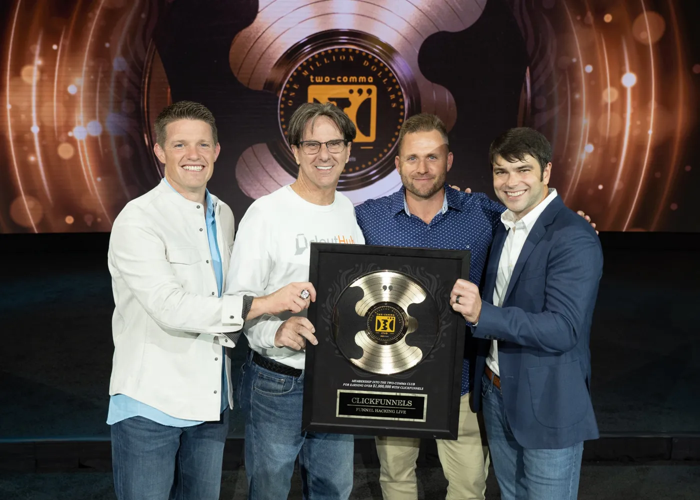 Bryan Dulaney with the CloutHub team and their Two Comma Club award