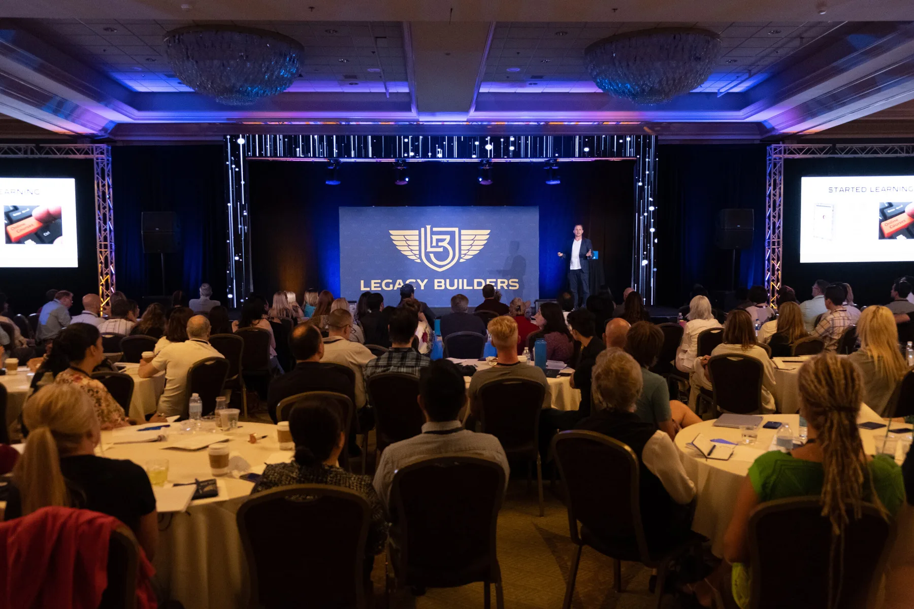 Bryan Dulaney speaking on stage at Legacy Builders LIVE