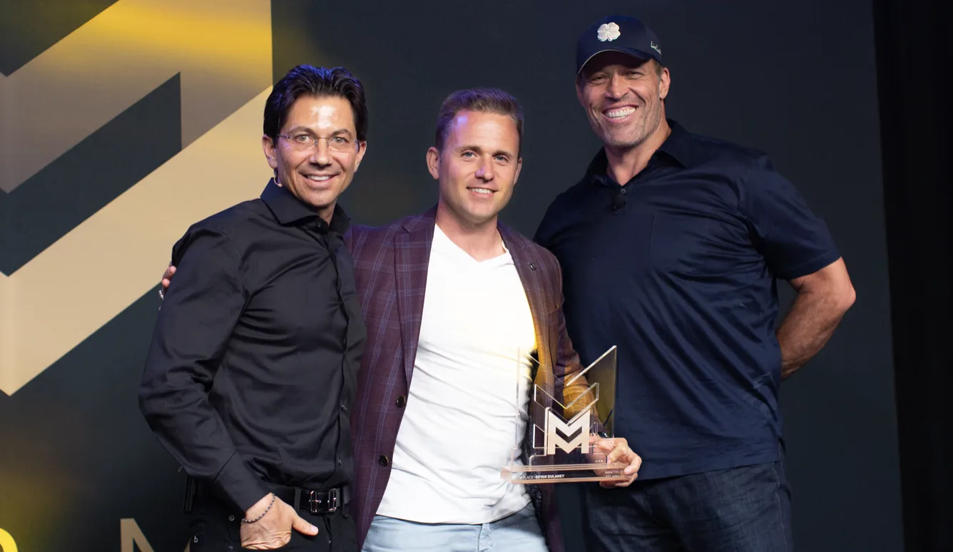 Bryan Dulaney with Dean Graziosi and Tony Robbins, receiving a top affiliate award